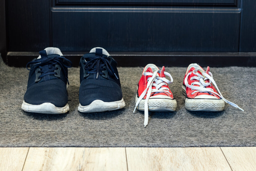 family-blue-shoes-and-red-sneakers-on-the-rug-at-t-2022-10-19-21-05-08-utc
