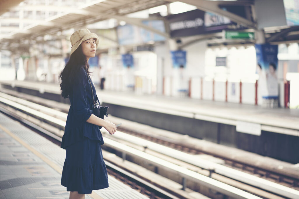 asian-girl-waiting-train-at-skytrain-station-for-t-2022-12-16-02-11-00-utc