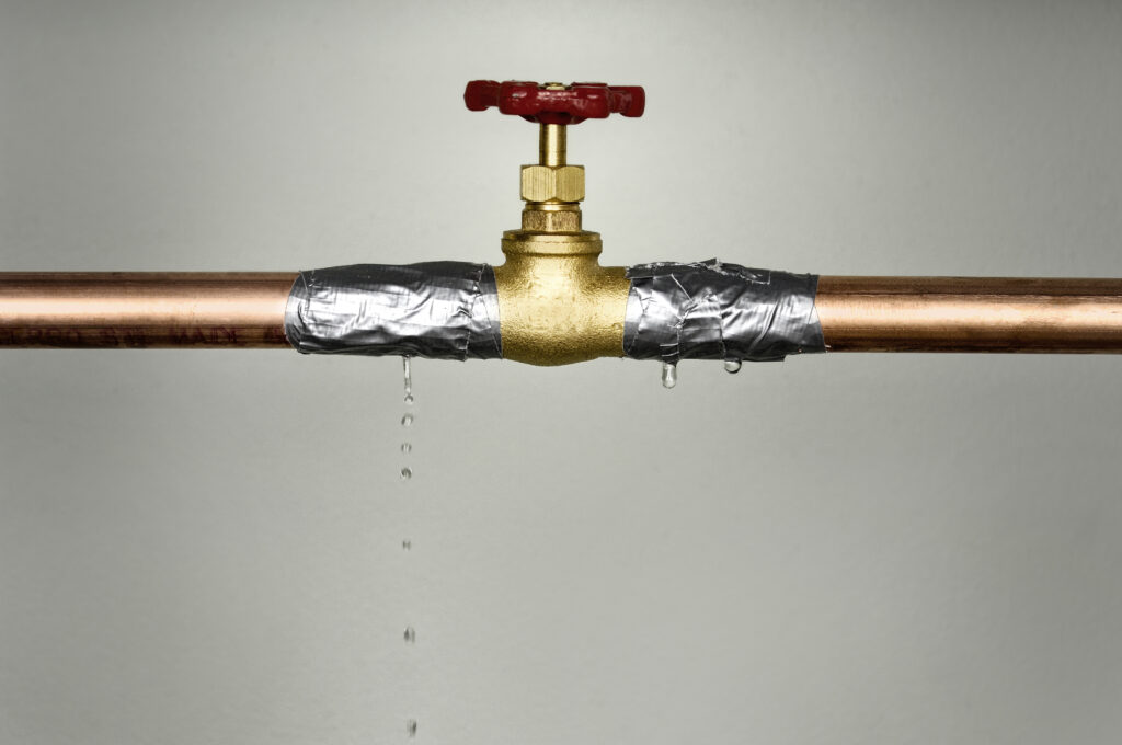 closeup-shot-of-the-leaking-water-pipe-with-red-va-2022-12-20-12-18-12-utc