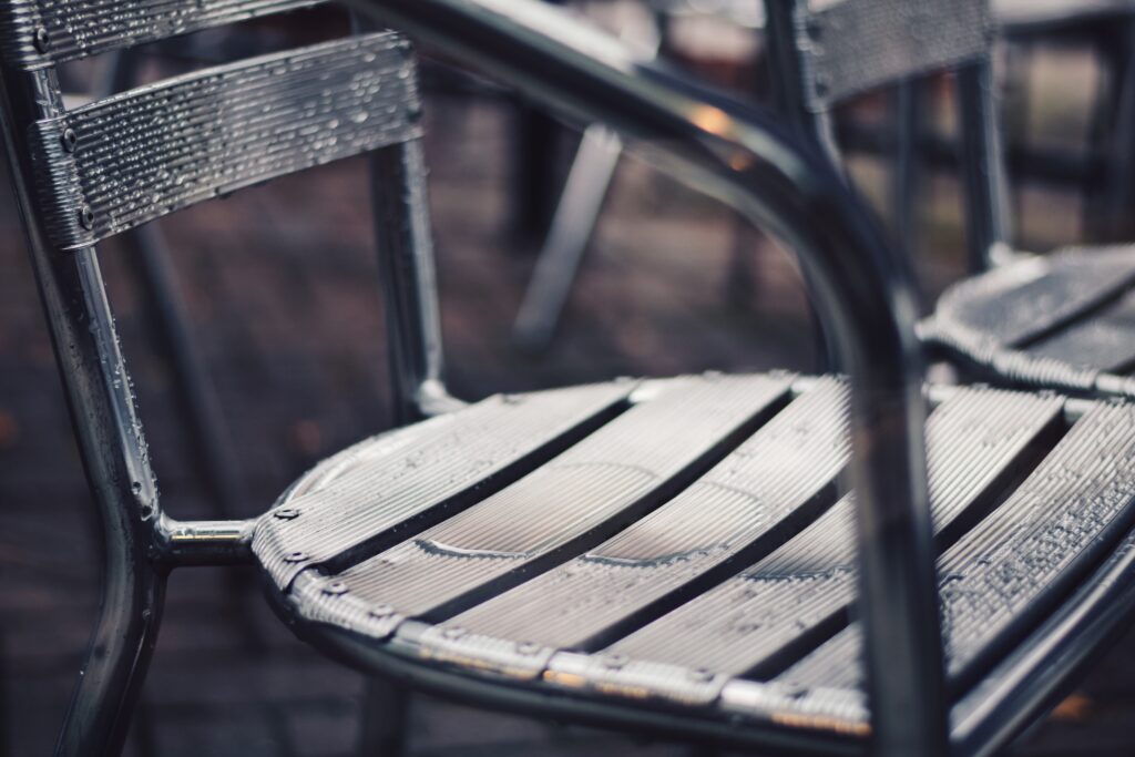 empty-outdoor-restaurant-metallic-patio-chairs-wet-2022-11-14-06-04-34-utc