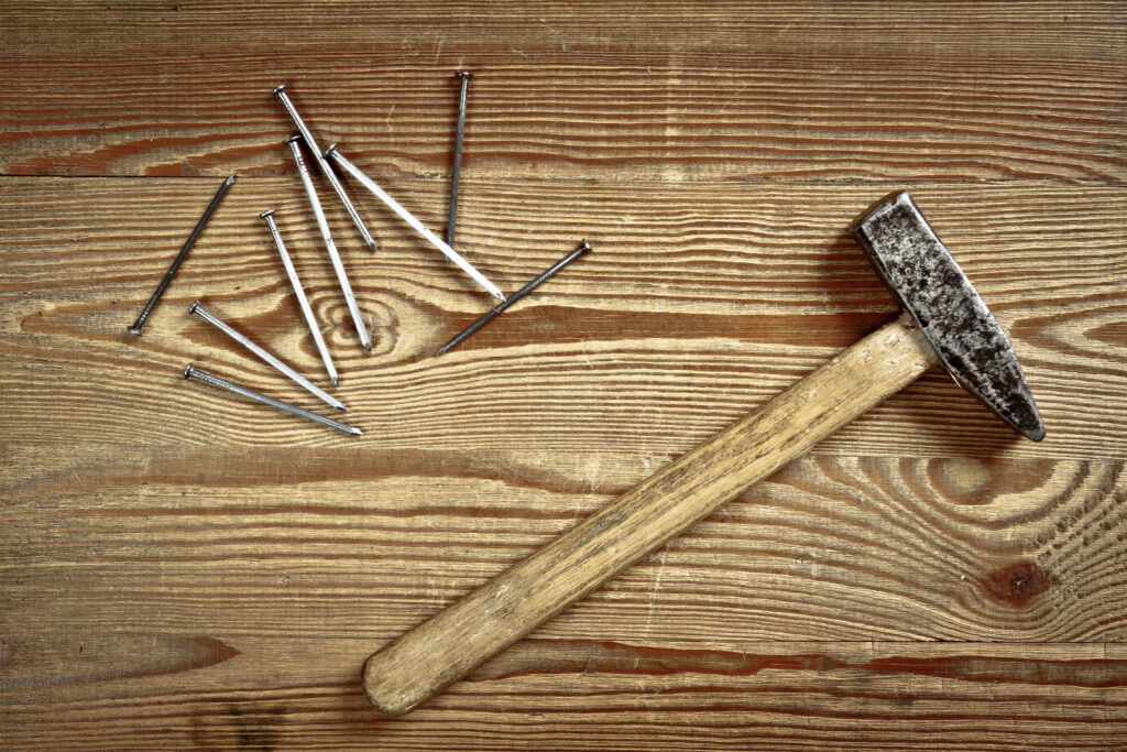 hammer-and-nails-on-old-wood-plank-2022-04-08-13-38-32-utc