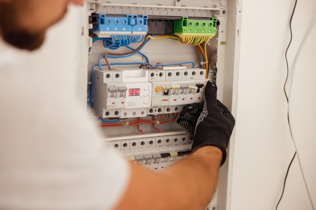 hand-of-electrical-technician-working-with-fuses-a-2022-09-06-03-44-34-utc