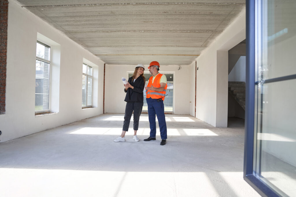 woman-engineer-talking-with-construction-worker-in-2022-01-04-22-22-59-utc