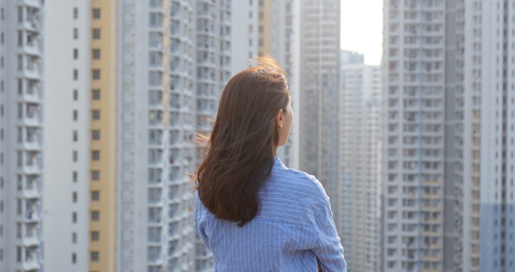 woman-look-at-the-city-with-building-at-sunset-tim-2022-12-15-20-36-09-utc