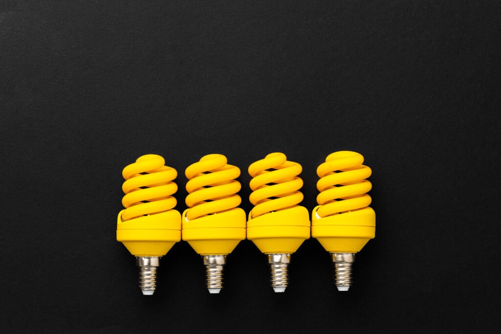 yellow-light-bulbs-on-black-background-top-view-2021-09-03-17-38-26-utc